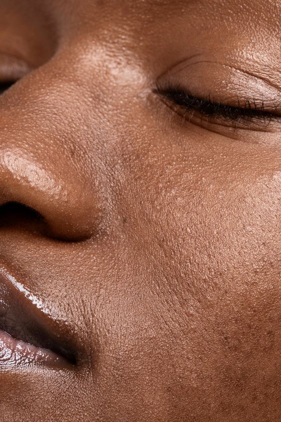 medik8 skincare on a black woman close up of her face