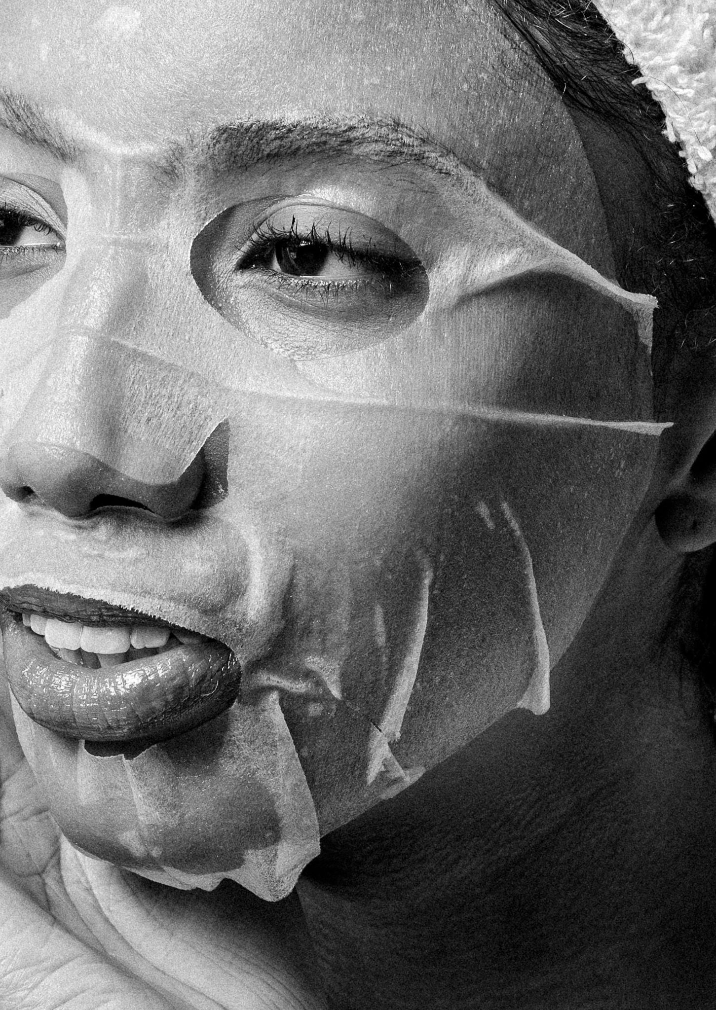 Black and white image of lady with sheet mask on